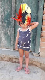 Full length of woman standing against wall