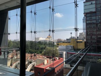 Bridge over buildings in city against sky