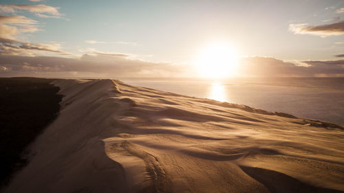 Scenic view of beach against sky during sunset