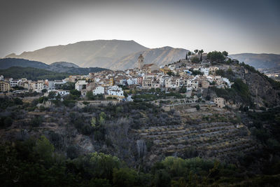 View of townscape and mountains against sky