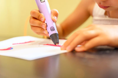 Close-up of woman holding hands at home