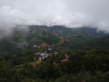 Scenic view of trees and mountains against sky