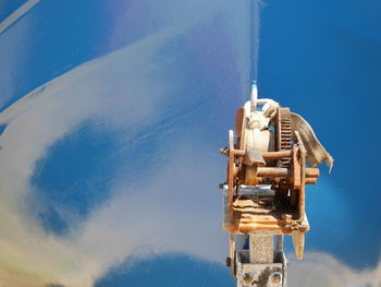 Close-up of coin-operated binoculars by sea against sky