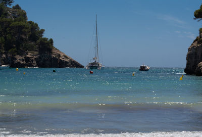 Sailboats sailing on sea against sky