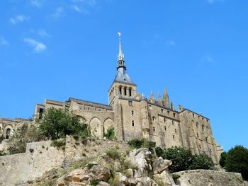 Low angle view of historical building against blue sky