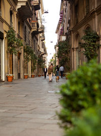 People walking on street amidst buildings in town