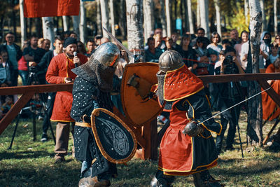 Rear view of people on field