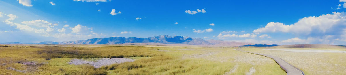 Panoramic view of landscape against blue sky