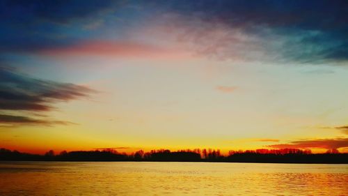 Scenic view of lake against sky during sunset