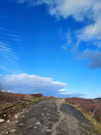 Empty road along countryside landscape