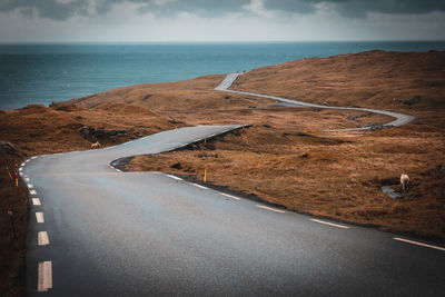 Road by sea against sky