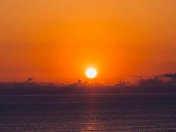 Scenic view of sea against romantic sky at sunset