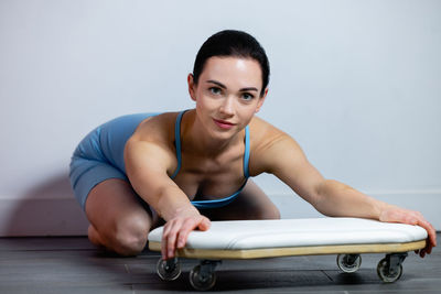 Portrait of young woman exercising at home