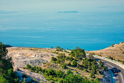 High angle view of road by sea against sky