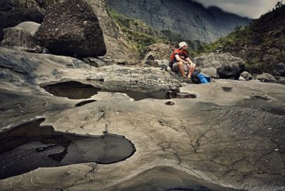 Low angle view of man climbing on mountain