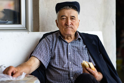 Portrait of man sitting outdoors