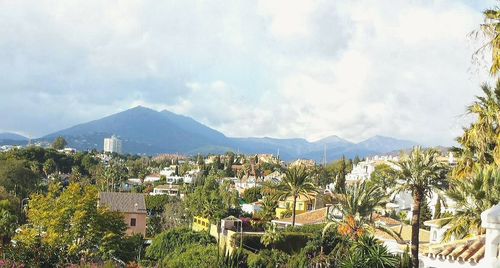 View of town against cloudy sky