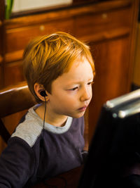 Boy using computer while sitting at home