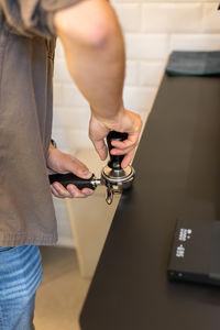 Midsection of man working in workshop