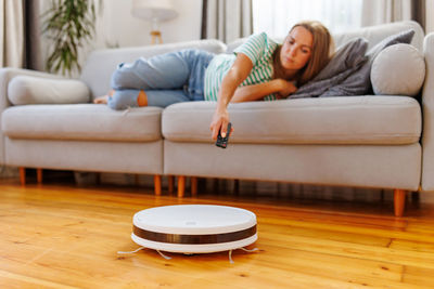 Young woman sitting on sofa at home