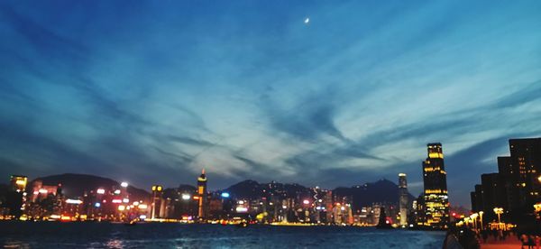 Illuminated buildings against sky at night