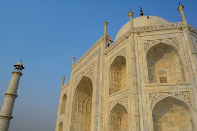 Low angle view of historical building against clear blue sky