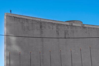 Low angle view of built structure against clear blue sky