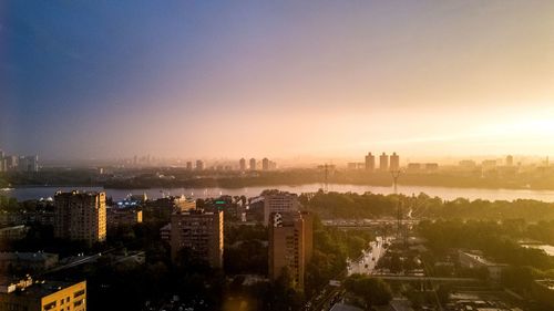 High angle view of buildings in city during sunset