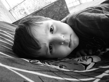 Portrait of cute baby lying on bed