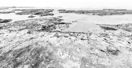 High angle view of rocks on beach against sky