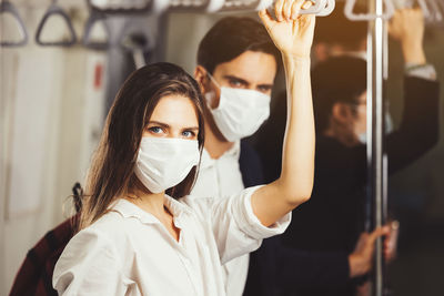 People on the train wear anti-virus masks and travel during rush hours. passengers inside the sky 
