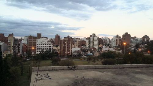 View of cityscape against cloudy sky