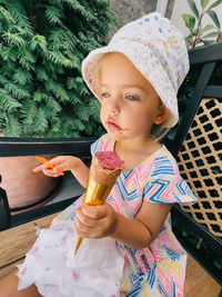 Portrait of cute girl blowing ice cream