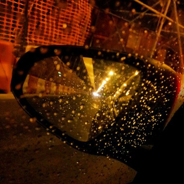 illuminated, close-up, indoors, night, reflection, transportation, glass - material, metal, no people, street, headlight, land vehicle, lighting equipment, car, high angle view, focus on foreground, light - natural phenomenon, selective focus, glowing, shiny