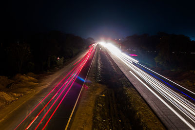 High angle view of light trails on highway at night