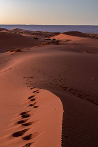 Scenic view of desert against sky during sunset