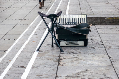 Accordion and stool on street