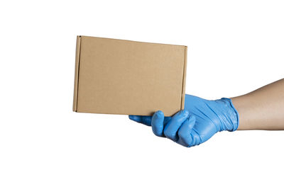 Midsection of woman holding paper against white background