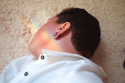 High angle view of man lying on bed