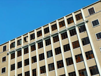 Low angle view of building against clear blue sky