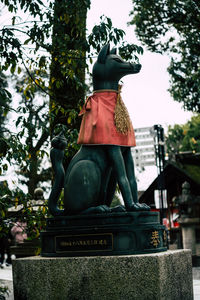 Low angle view of statue against trees