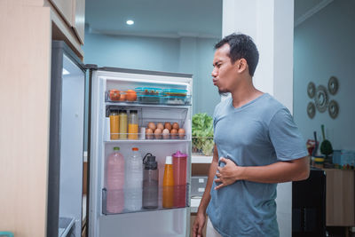 Man looking at food at home