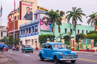 Cars on road against buildings