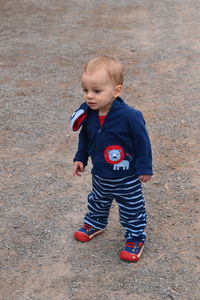High angle view of cute boy standing outdoors