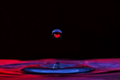 Close-up of water drop against black background