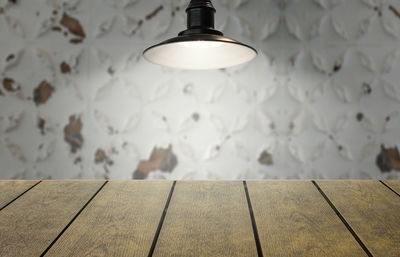 Close-up of illuminated light bulb on wall