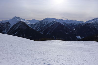 Scenic view of snow covered mountains against sky