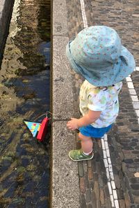 Low section of girl playing on sidewalk