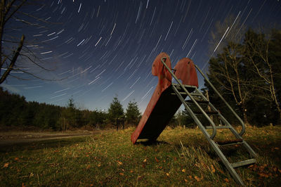 Lifeguard hut on field against sky at night