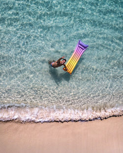 Aerial view of man enjoying at seashore